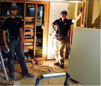 Two men working on a home restoration